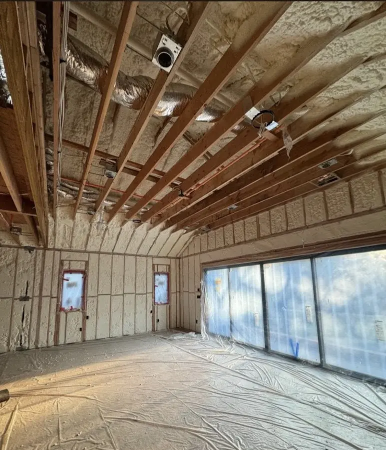 Interior walls and ceiling insulated with spray foam during new construction in Turpin Hills